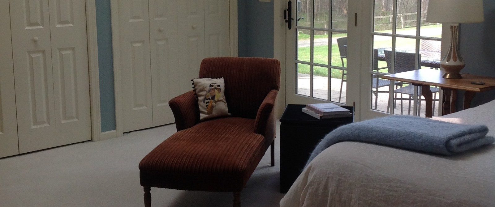 burgundy lounge chair with a window behind