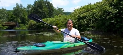 Doug on a green kayak on the river