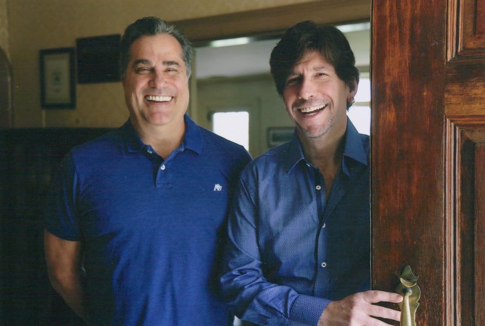 the innkeepers doug and jim blue shirts standing in the Inn