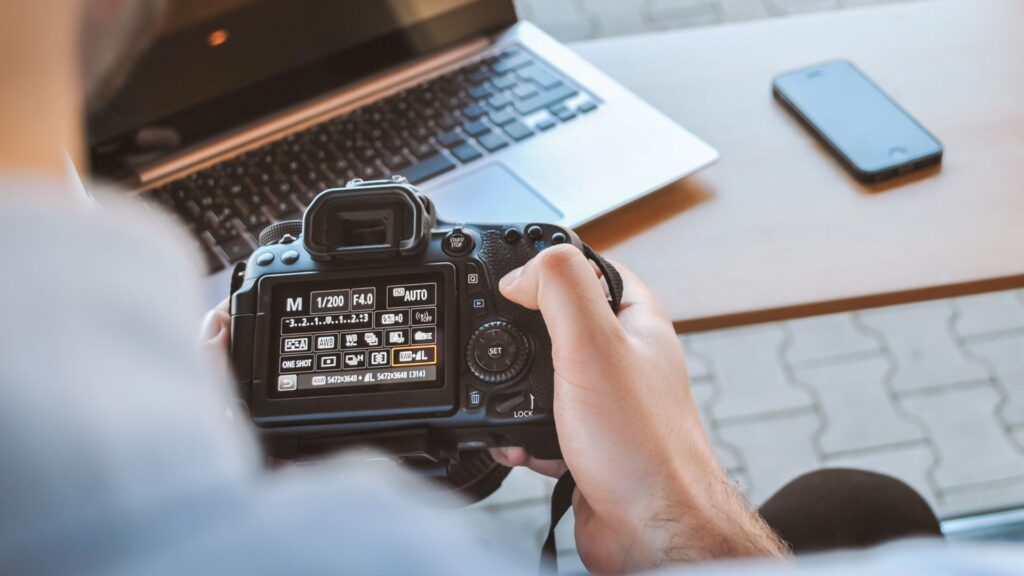 A person is adjusting settings in manual mode on a DSLR camera