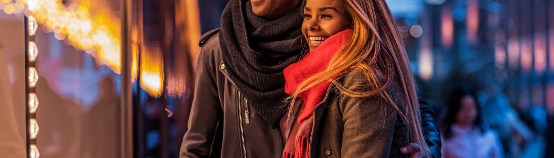 man and woman holiday window shopping