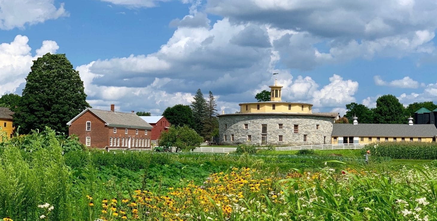 Exterior view of Hancock Shaker Village, an historic living museum surrounded by acres of lush landscaping