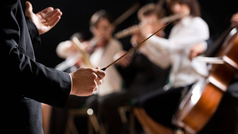 A conductor leading an orchestra