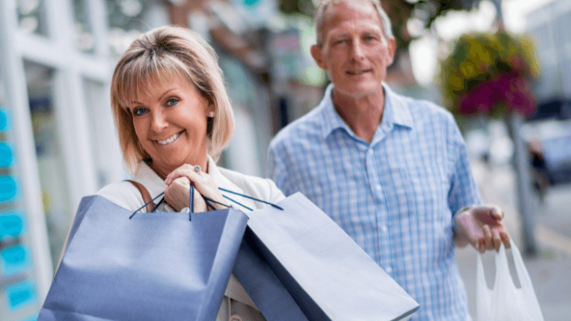 Couple smiling holding shopping bags