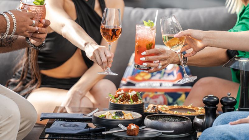 Friends toasting wine goblets while out to dinner