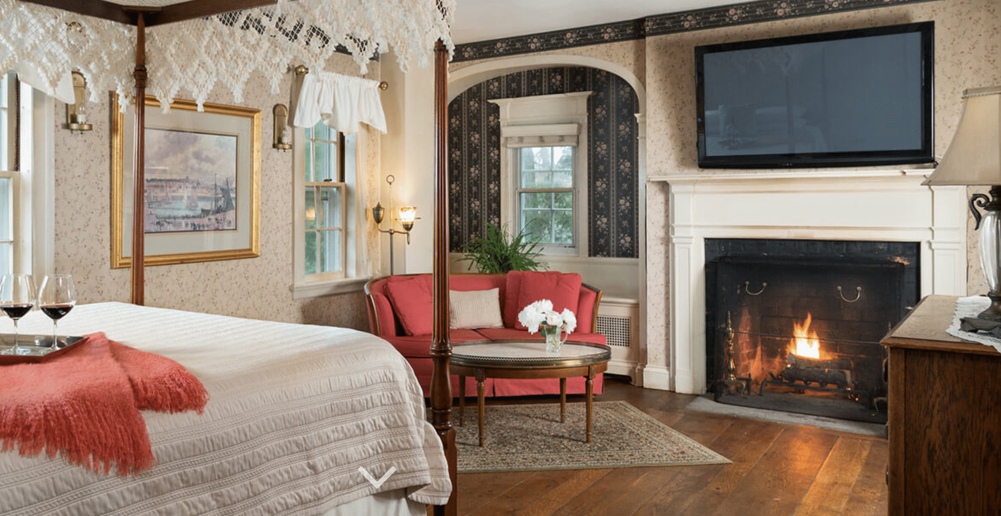 guest suite with fireplace and canopy bed