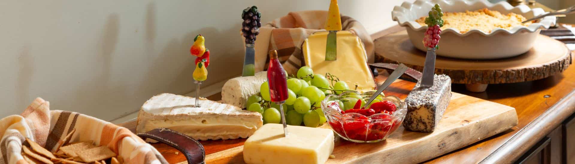 Buffet with crackers, cheese, fruit, dips, and spreads