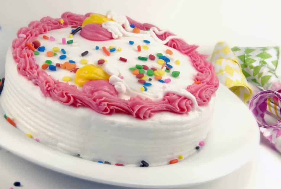 Close up view of a birthday cake on a white plate